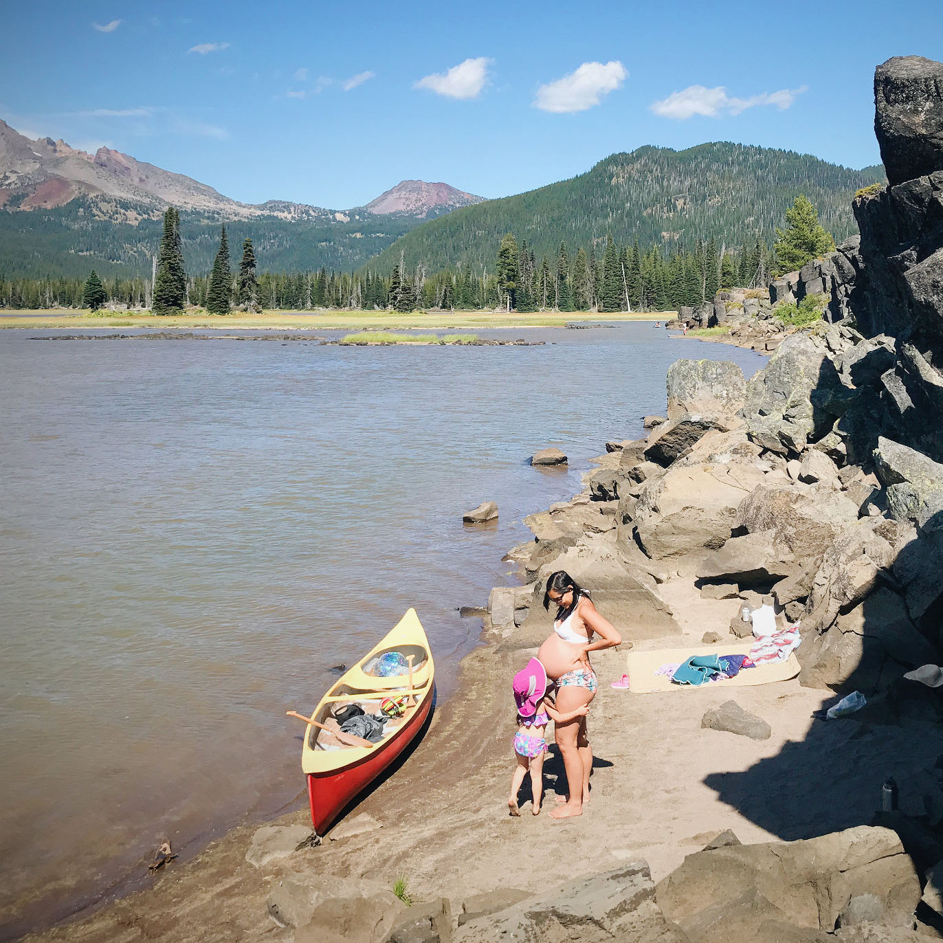 Linda Ly and child on a lake shore with a canoe